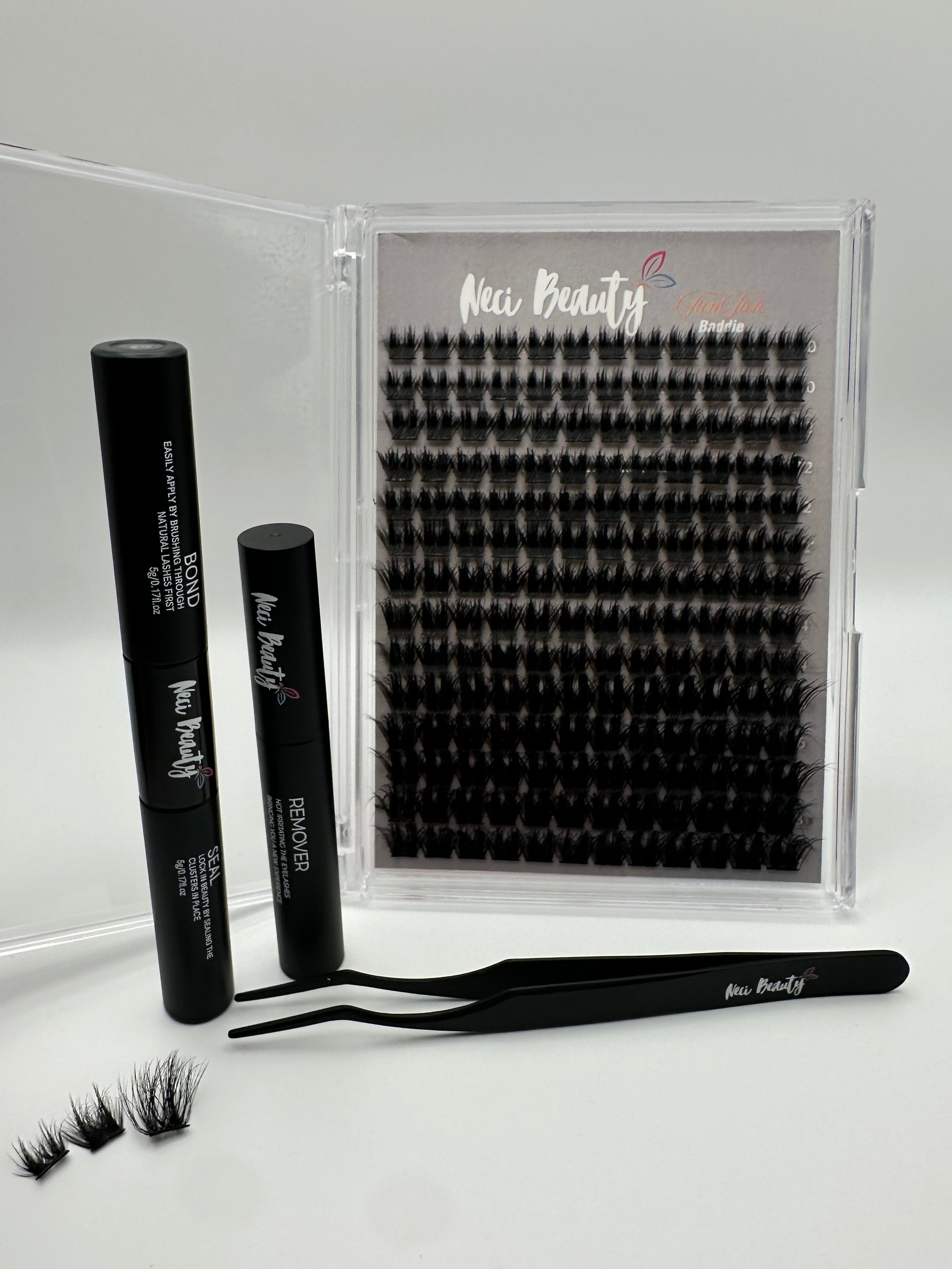 Eyelash extension kit with tweezers and removers on a white background