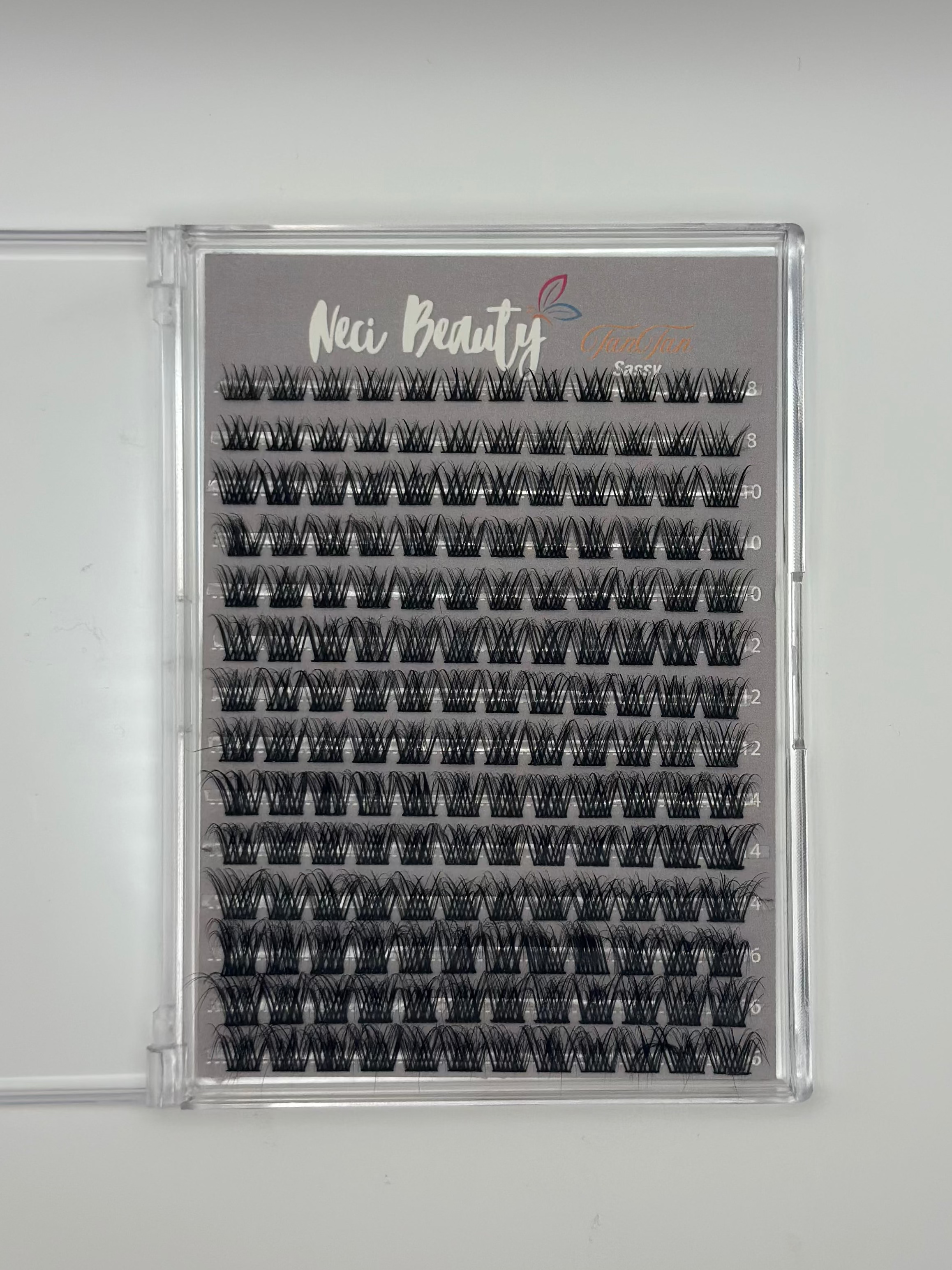 Eyelash extension tray with 'Neci Beauty' branding on a gray background
