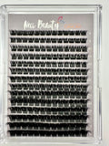 Eyelash extension tray with multiple rows of false eyelashes on a gray background