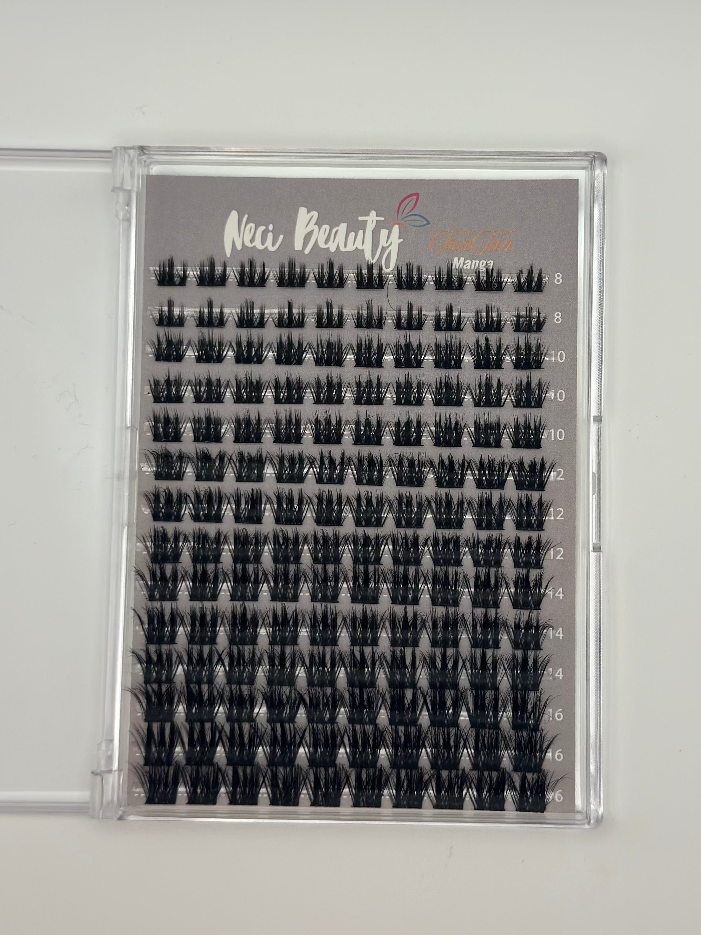 Set of false eyelashes in an open case on a gray background