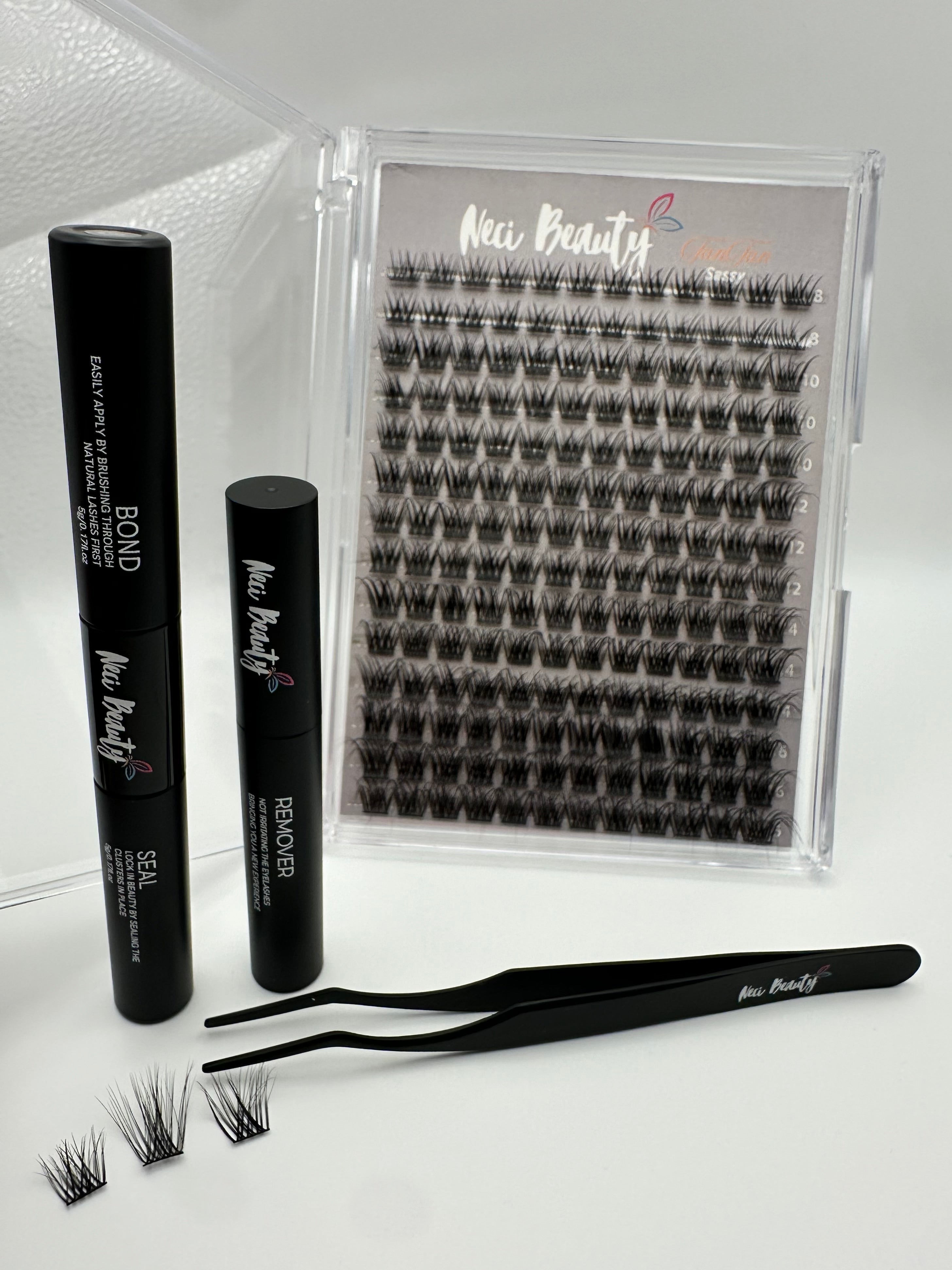 Set of false eyelashes with applicator and remover on a white background