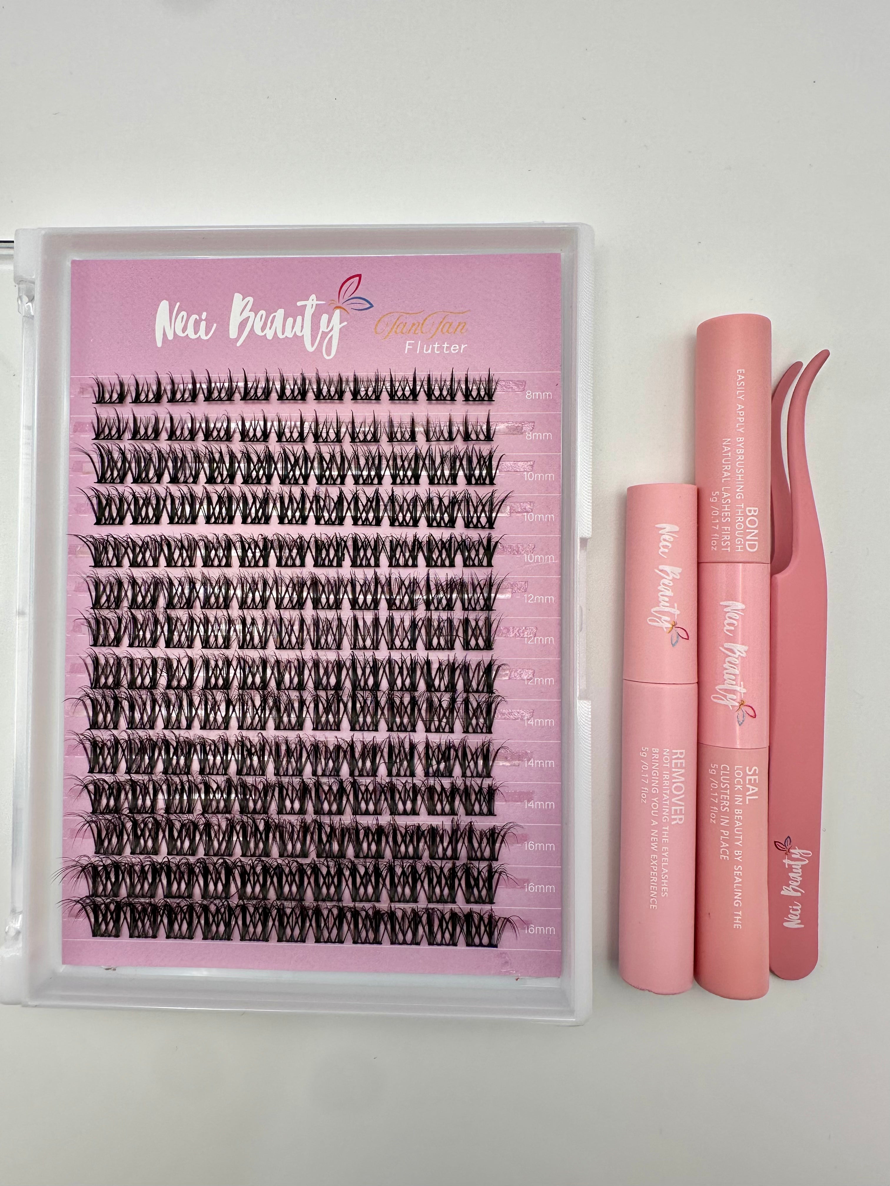 Set of false eyelashes with applicator and tweezers on a white background