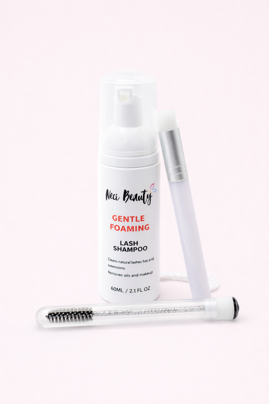 Set of skincare products including a bottle, brush, and tube on a white background